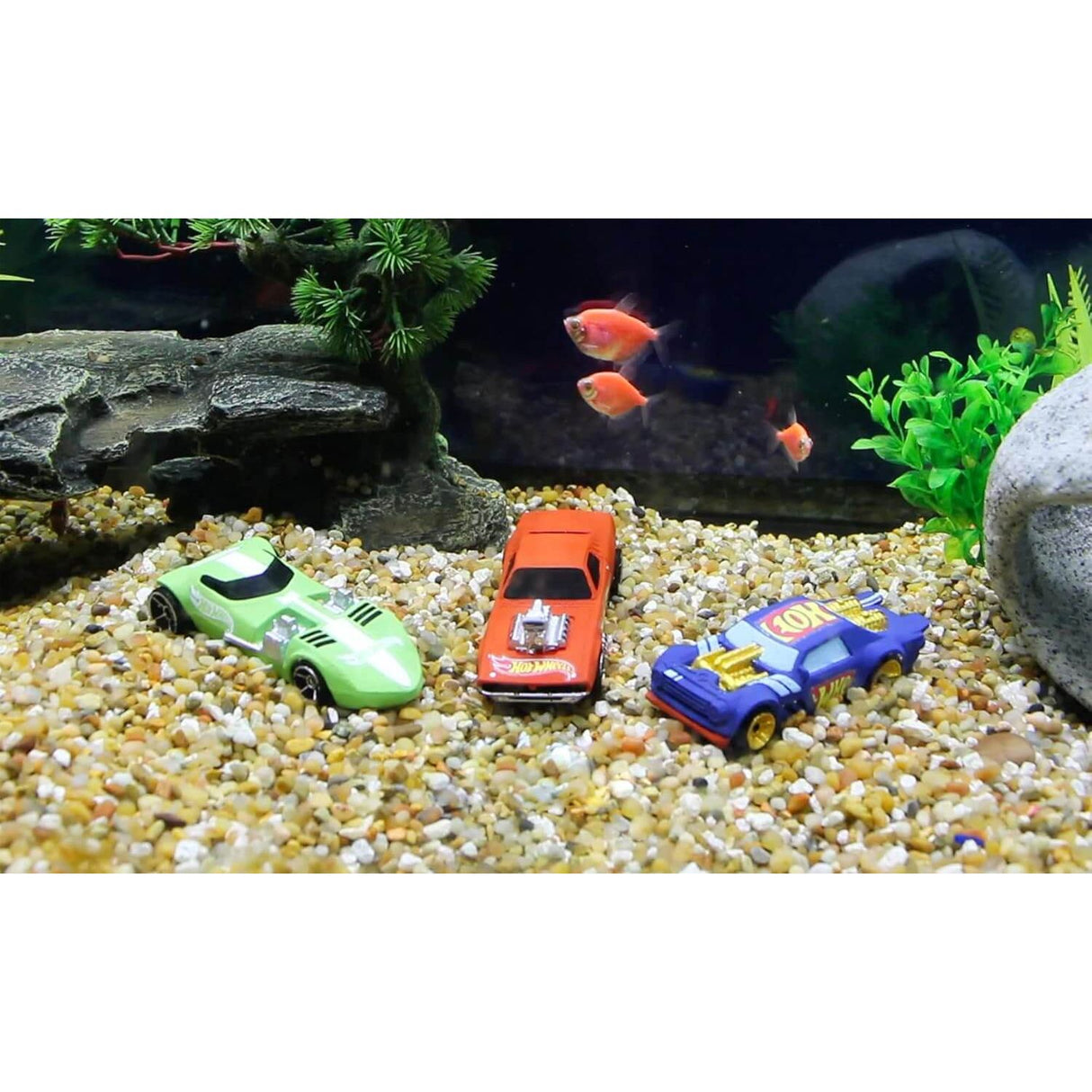 Penn-Plax Hot Wheels Cars Aquarium Decoration Bundle featuring toy cars surrounded by gravel and fish.