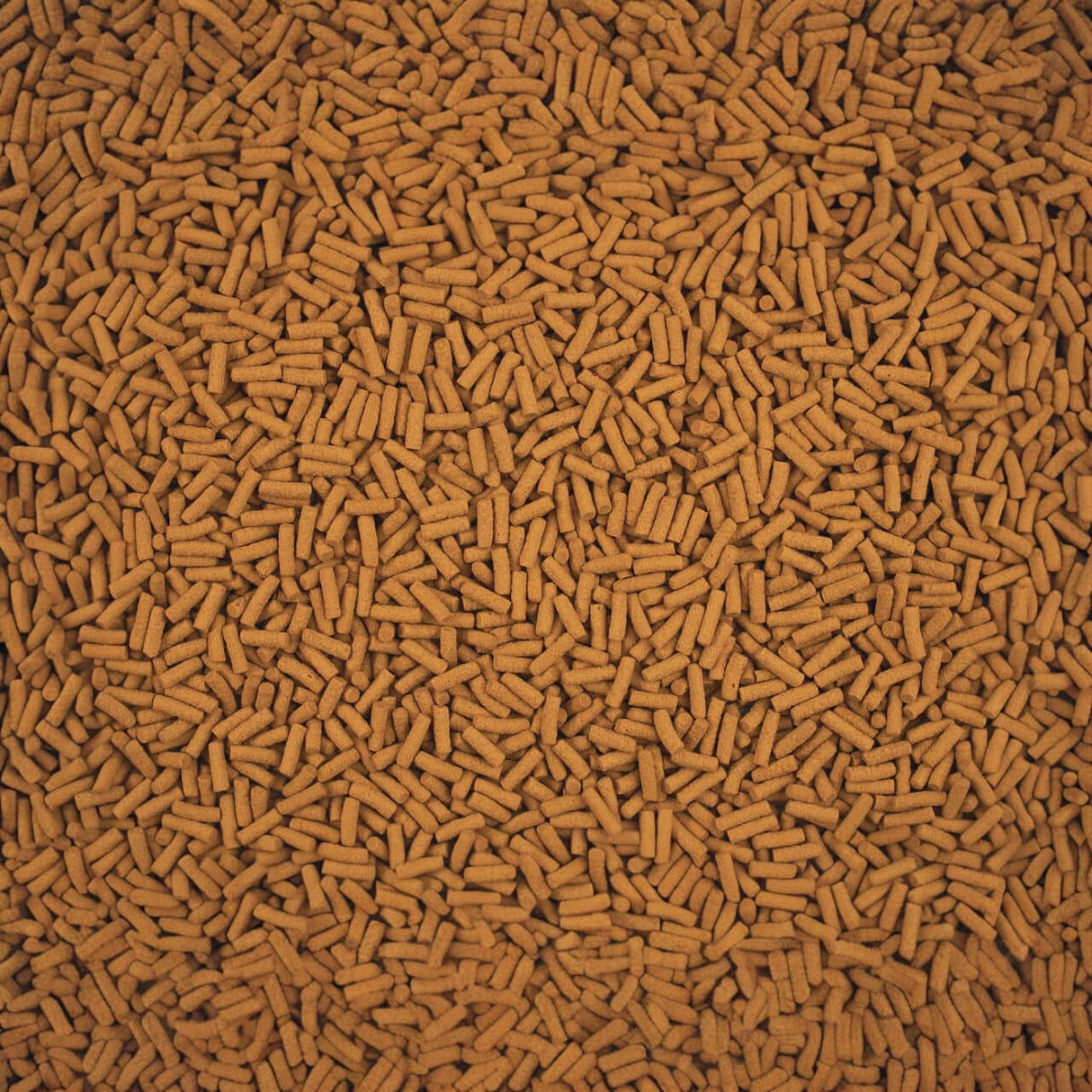 Close-up of Tetra Cichlid Sticks, a high-quality staple food for cichlids and large ornamental fish.