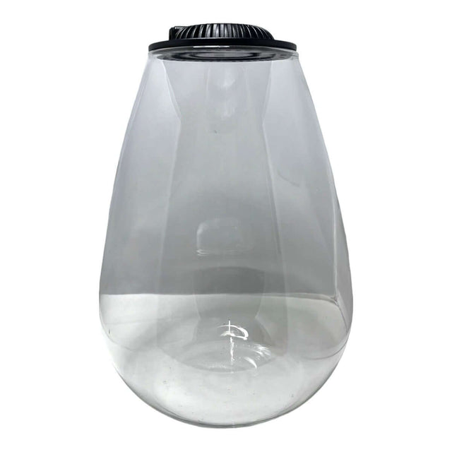 Clear teardrop glass terrarium with black lid for creating indoor plant ecosystems.