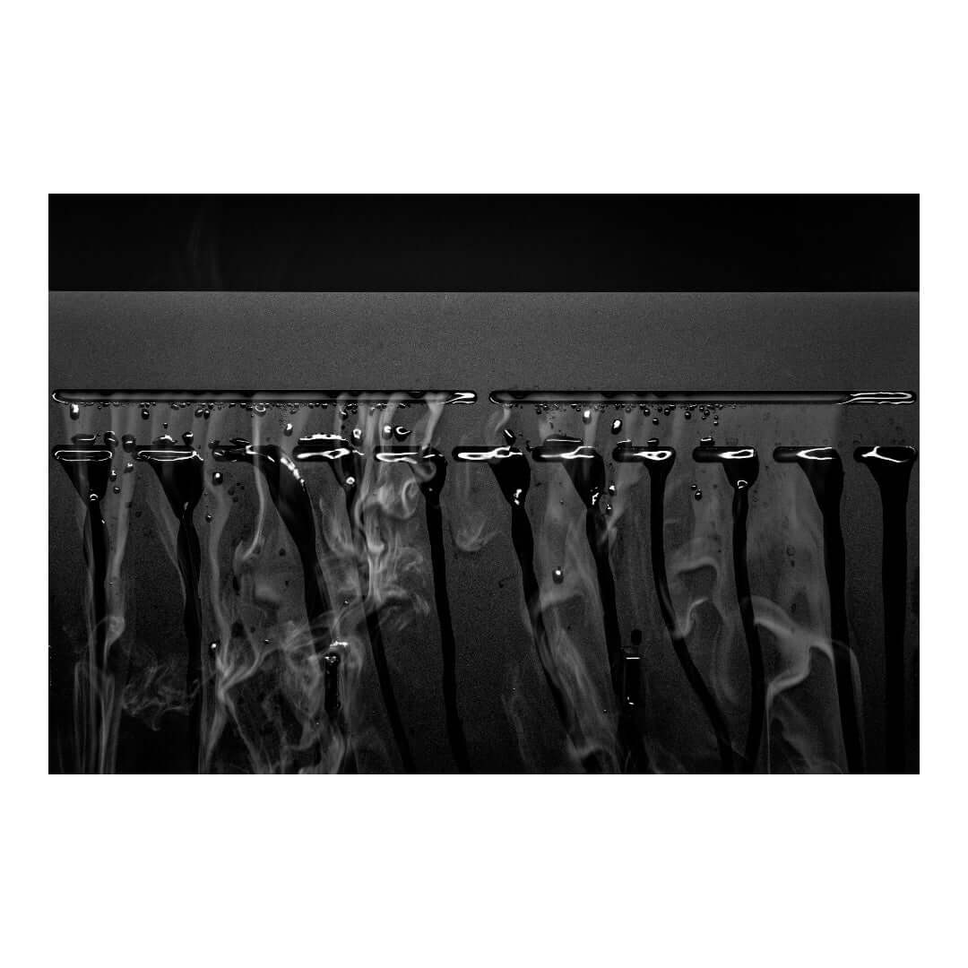 Close-up of cascading water droplets with mist effect, showcasing UNS Foresta Paludarium's built-in waterfall feature.