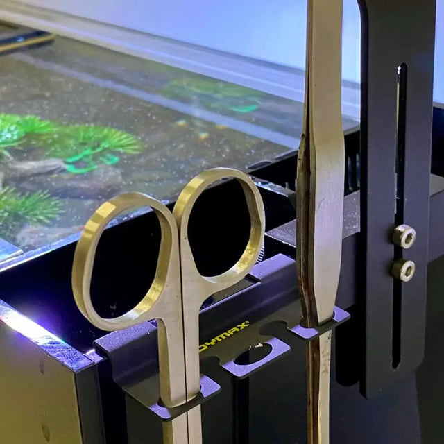 Dymax aquascaping tools holder displaying stainless steel scissors and tweezers securely mounted on an aquarium.