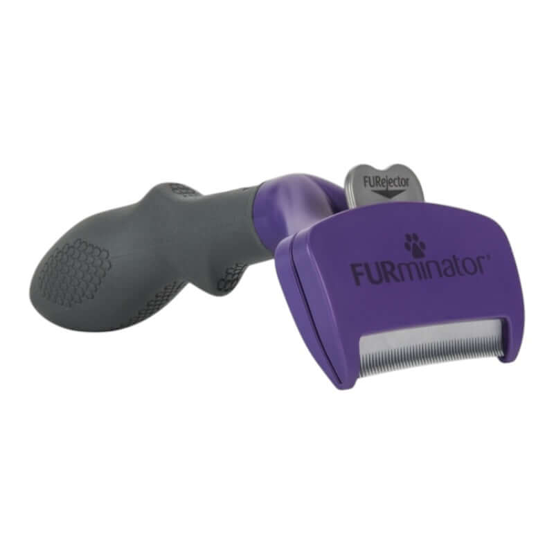 Furminator Cat DeShedding Tool for Long Hair with ergonomic handle and stainless steel edge to reduce shedding.