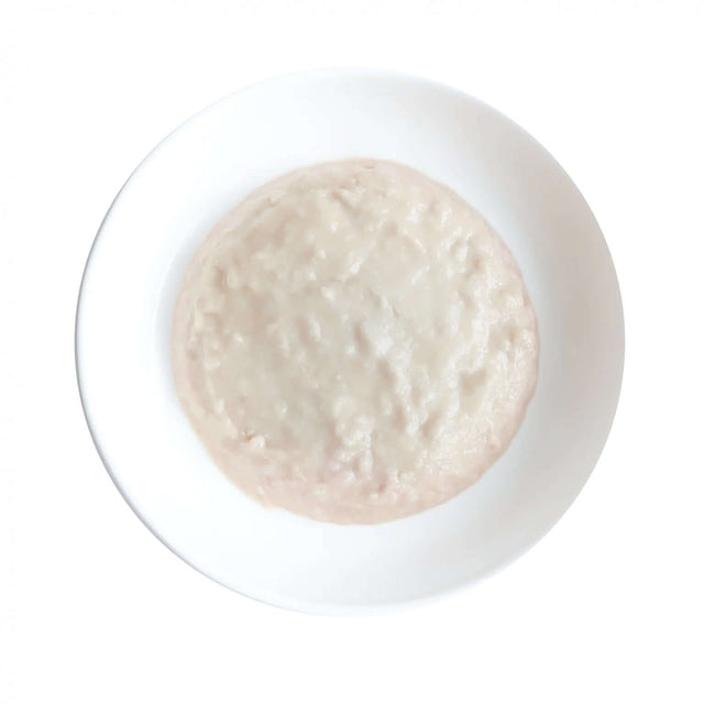 Kit Cat Kitten Chicken Mousse on a white plate, smooth texture, grain-free, nutritious cat food for all life stages.