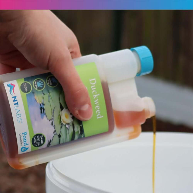 NT Labs Cristalclear Duckweed Control 250ml bottle being poured into a container, effective pond treatment.