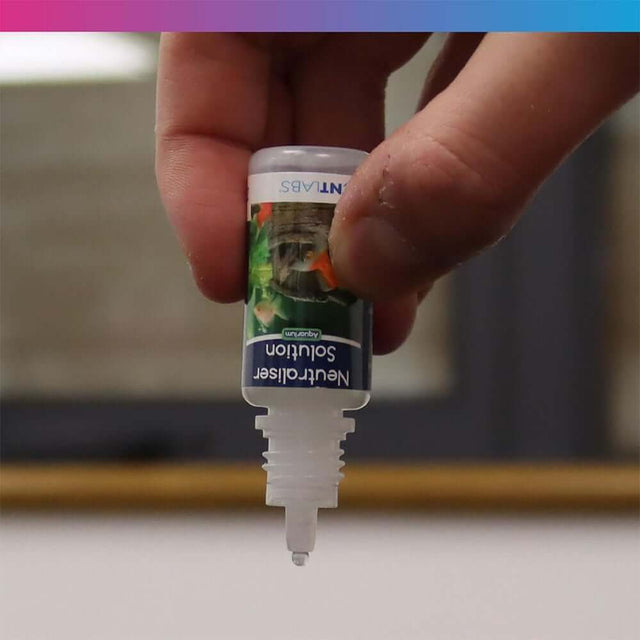 NT Labs Plastic Plant Cleaner bottle being held, ideal for cleaning aquarium plants and ornaments.