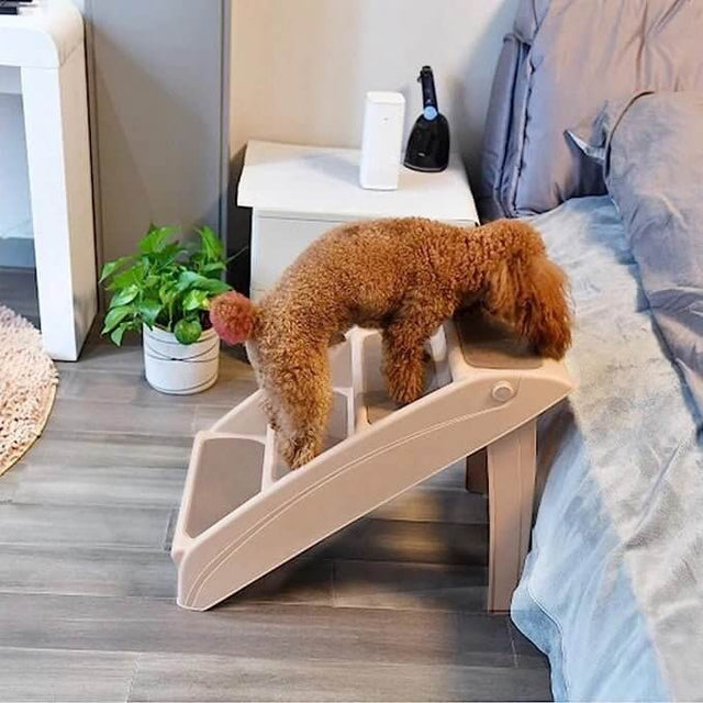 Small dog using Pawise Pet Steps to reach a bed, aiding mobility for pets with special needs.