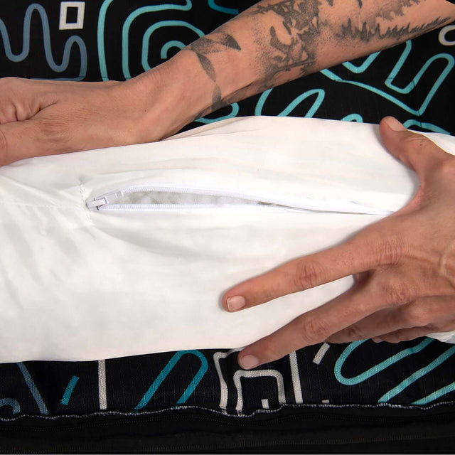 Person holding a white zippered cover of the Rogz Graphix Walled Dog Bed, showcasing its durable design.