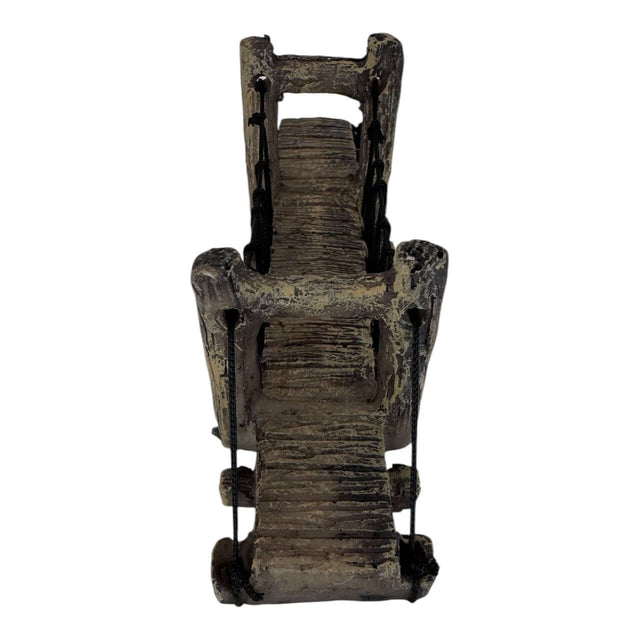 Suspension bridge aquarium ornament with textured support posts, ideal for miniature landscapes in aquariums or terrariums.