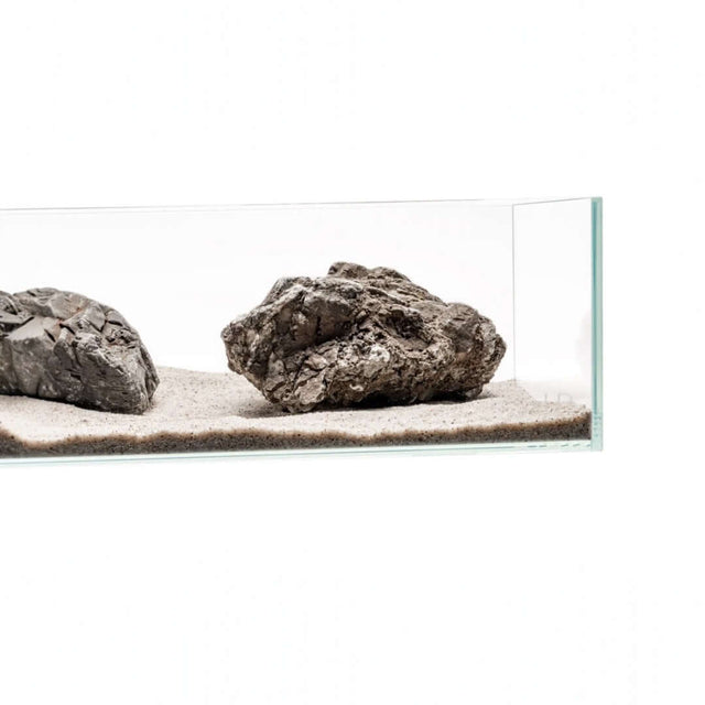 Aquarium setup showcasing natural rocks on a sandy substrate, ideal for aquascaping with UNS Controsand.