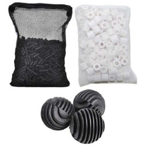 Assorted aquarium filter media including black bag of pellets, white cylindrical media, and black spherical filter balls.