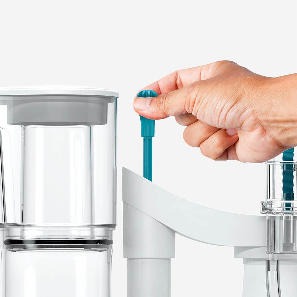 Close-up of a hand adjusting the flow control on an Aquavitro Division Protein Skimmer for optimal performance.