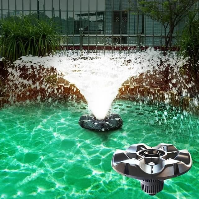 Boyu Floating Fountain Air Pump with LED creating a stunning water display in a vibrant green pond.
