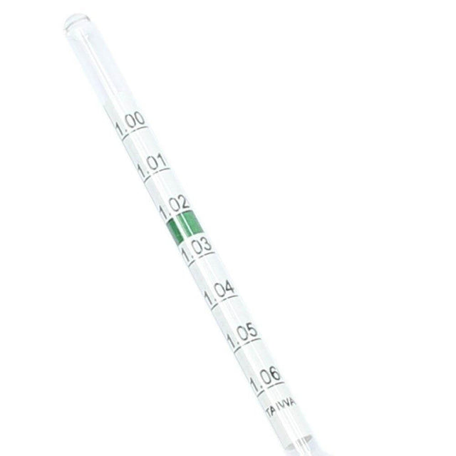 Floating glass hydrometer with thermometer showing precise measurements for aquarium water conditions.