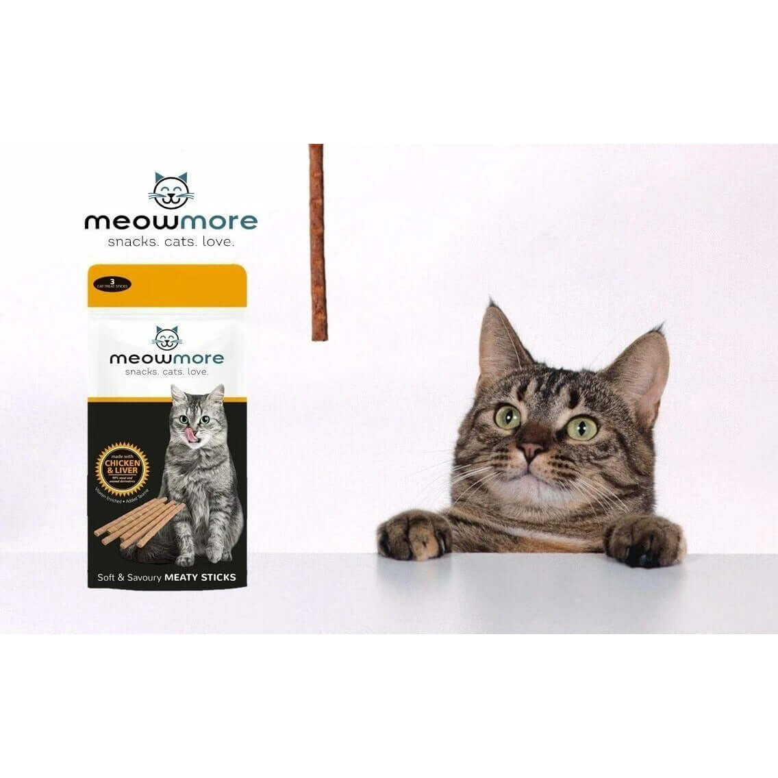 Cat eagerly reaching for Meow More Cat Treat Sticks 3-Pack, featuring soft and savoury meaty sticks for healthy snacking.