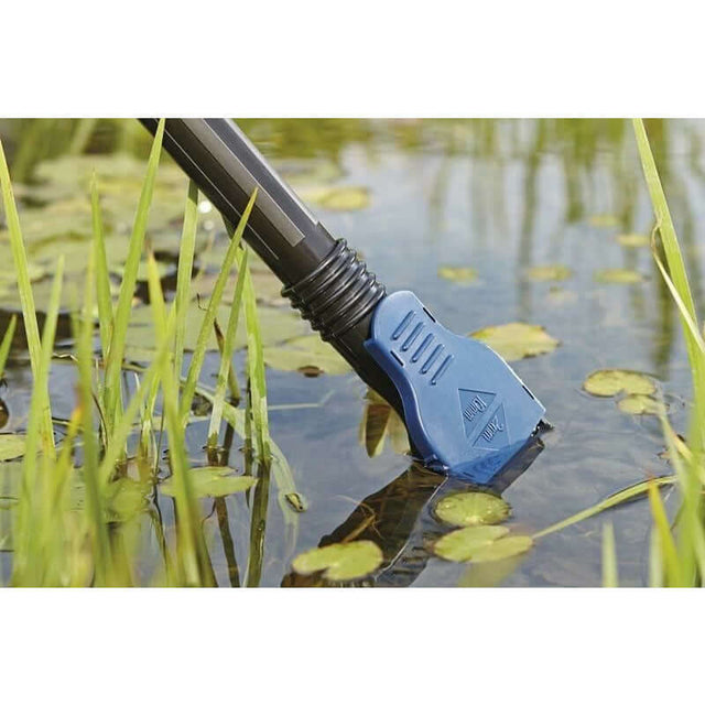 Oase Pondovac Classic vacuum cleaner nozzle in pond among lily pads for effective sludge removal.