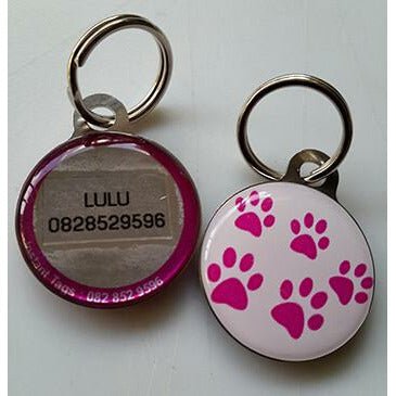 Pet ID Tag with pink paw prints and personalized details for pet safety and identity.