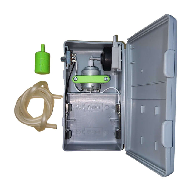 Whale B-21 Portable Battery Air Pump interior showing pump, tubing, and green cap for aquarium use.