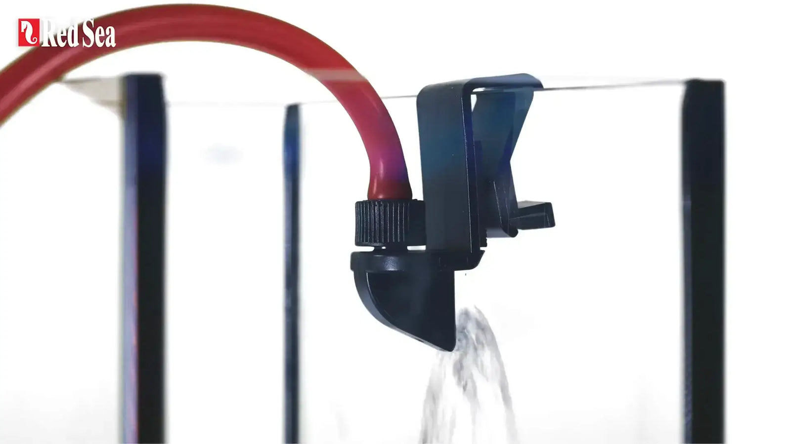 Red Sea ReefATO water dispensing system with a red tube and black clamp attached to an aquarium.