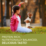 Acana Puppy Small Breed Recipe Dry Dog Food 2kg with a girl feeding a puppy, showcasing protein-rich ingredients.