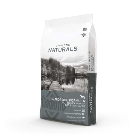 Diamond Naturals Senior Dog Formula Rich in Chicken with Eggs and Oat Flakes Dry Dog Food packaging on a scenic background.