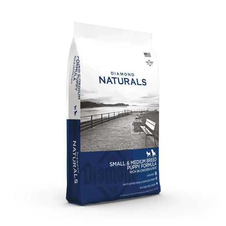 Diamond Naturals Small and Medium Breed Puppy Formula Rich in Chicken and Rice Dry Dog Food packaging on a scenic background.