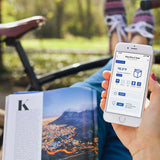 Person checking Maxspect DICE Pico 2 AIO Freshwater Aquarium app on smartphone outdoors.