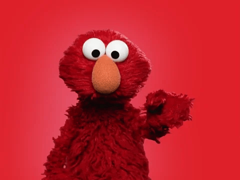 Elmo, the iconic red puppet from Sesame Street, waving cheerfully against a vibrant red background.