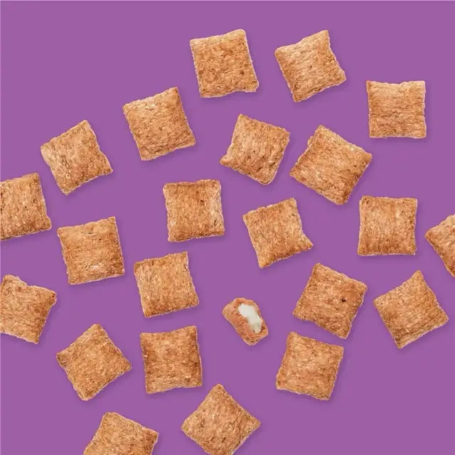 Meow Munchies Crunchy Cat Bite Treats arranged on a purple background, featuring a crunchy exterior and creamy filling.
