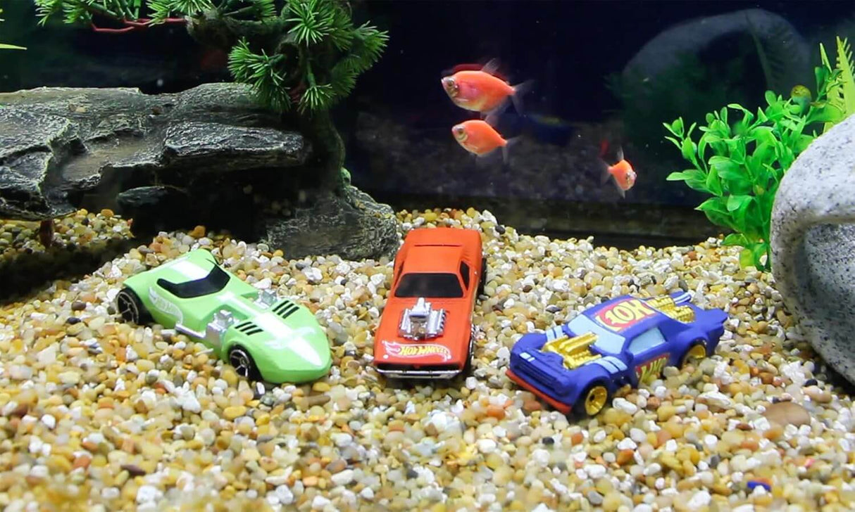 Penn-Plax Hot Wheels Cars Aquarium Decoration Bundle featuring toy cars surrounded by gravel and fish.