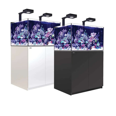 Red Sea Reefer G2+ 300 Aquarium in white and black cabinets with vibrant coral reef display and LED lighting.