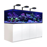 Red Sea Reefer G2+ S1000 Aquarium featuring vibrant corals and sleek white cabinet with LED lighting.