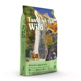 Taste of the Wild Feline Rocky Mountain Cat Food bag with roasted venison and smoked salmon background.
