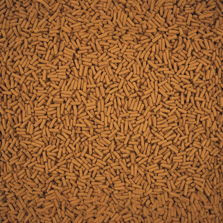 Close-up of Tetra Cichlid Sticks, a high-quality staple food for cichlids and large ornamental fish.