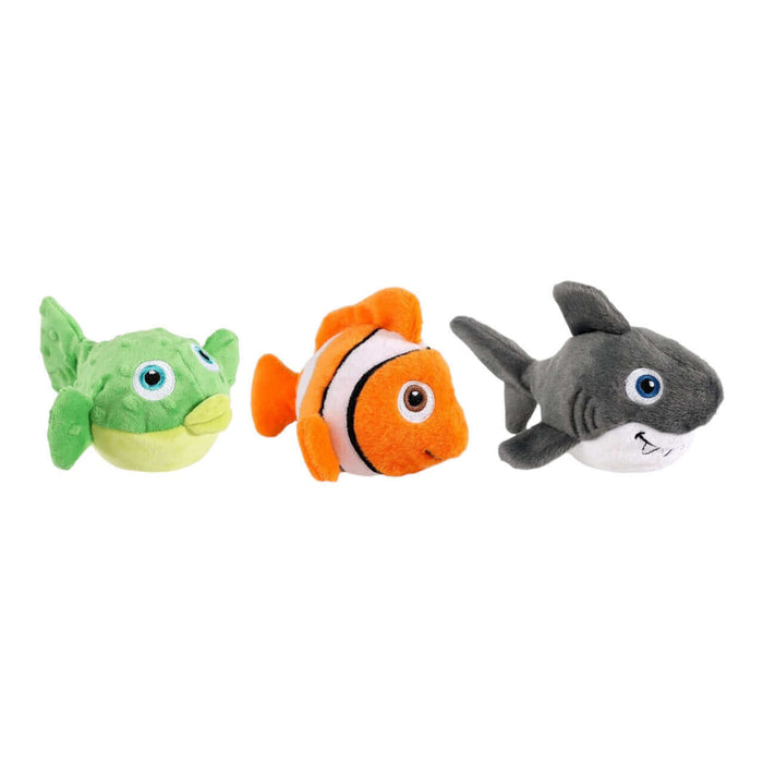 Three plush sea-life toys for dogs, featuring a green fish, an orange clownfish, and a gray shark.