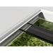 Chihiros Universal WRGB aquarium light positioned on Juwel Aquarium, showcasing sleek design and rich greenery below.