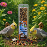 Cockatiels enjoying a Coconut and Berries Seed Stick treat surrounded by flowers and colorful seeds.