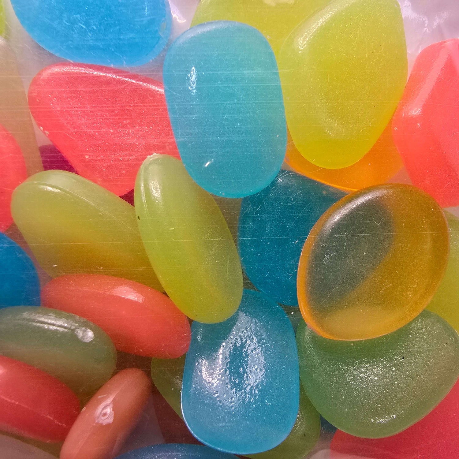 Colorful Glow In The Dark Stones in various shapes for decorative uses in gardens and home décor.