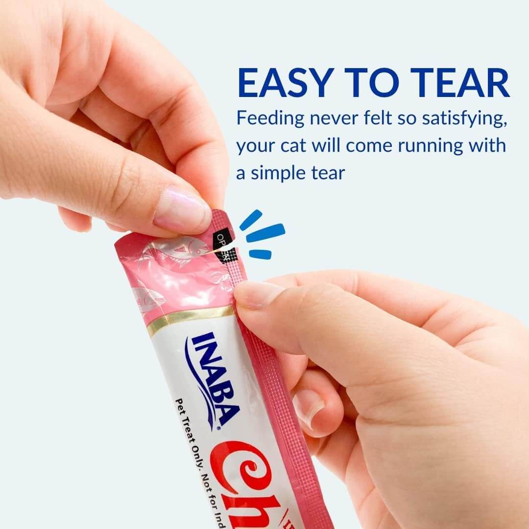 Hands opening an Inaba Churu treat pouch, showcasing the easy tear design for convenient feeding.