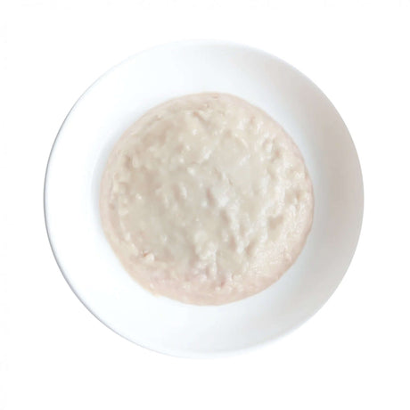 Kit Cat Kitten Chicken Mousse on a white plate, smooth texture, grain-free, nutritious cat food for all life stages.
