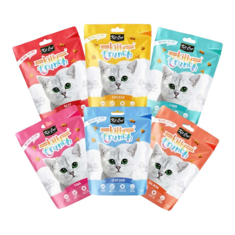 Kit Cat KittyCrunch cat treats in seven colorful bags, featuring tasty flavors like tuna, chicken, lamb, and seafood.