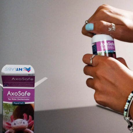 A person opening NT Labs AxoSafe aquarium dechlorinator bottle, showcasing its use for axolotls.