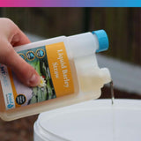 Pouring NT Labs Barleyclear Liquid Barley Straw into a container, effective algae control for ponds.