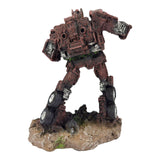 Red Transformer Ornament standing on a textured base with mechanical detailing and a weathered finish.