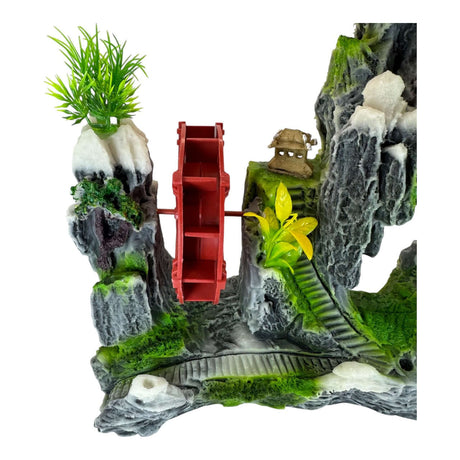 Rock with red waterwheel aquarium ornament creating a serene landscape with plants and rocks.