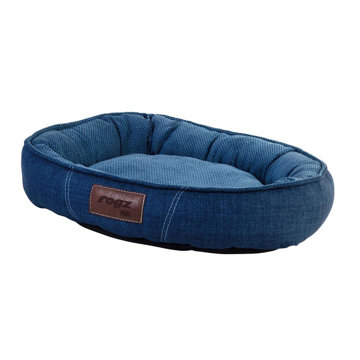 Rogz Lounge Oval pet bed in blue, featuring a cozy bolster and soft cushioning for medium dogs. Size: 56 x 39 x 13cm.