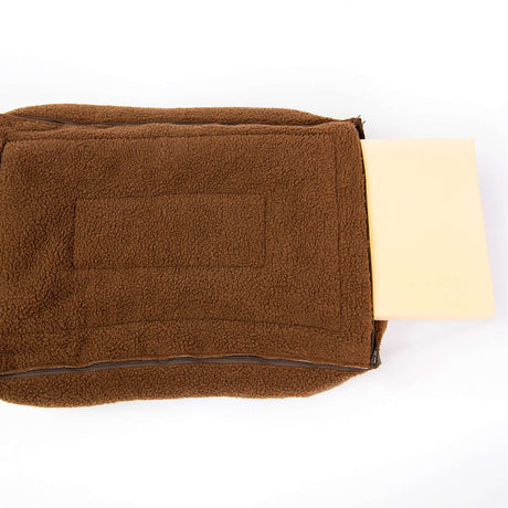 Close-up of a brown fleece dog bed with a removable foam mattress insert on a white background.
