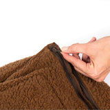 Close-up of a hand unzipping the durable fabric of the Rogz Outdoor Walled Dog Bed for easy maintenance.