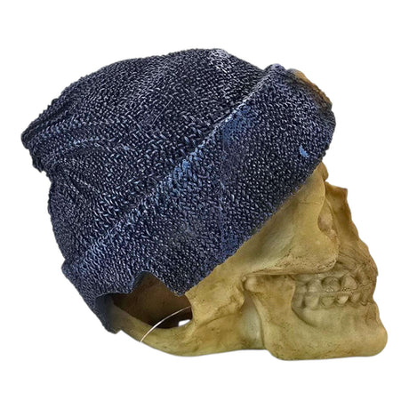 Decorative skull figurine with a textured bone finish and dark blue knitted beanie, adding edgy charm to any space.