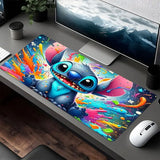 Vibrant Stitch mouse pad 80x40cm with colorful paint splatters enhancing the desk workspace decor.