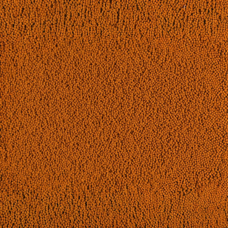 Close-up of Tetra Cichlid Colour Pellets showcasing vibrant orange color and fine texture, ideal for cichlid nutrition.